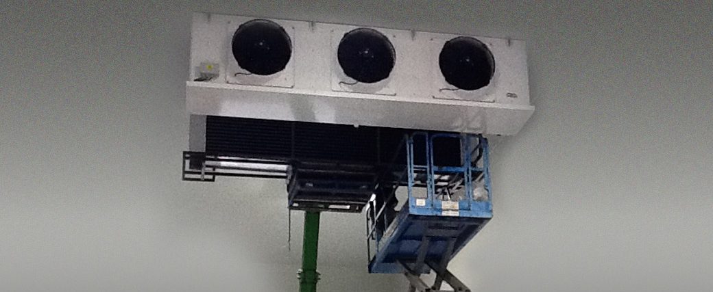 industrial refrigeration equipment being lifted on a knuckle boom