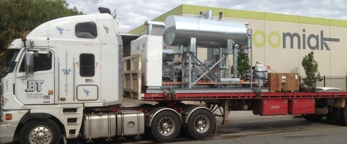 spiral freezer on a truck in front of an oomiak office building