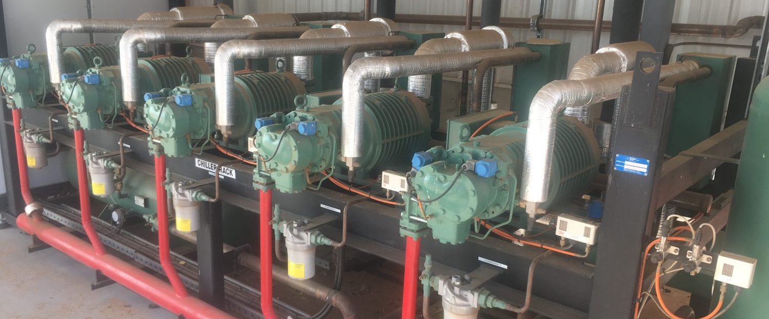 an industrial refrigeration plantroom with multiple pieces of equipment