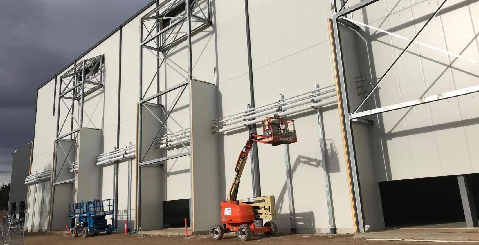 exterior of building with a knuckle boom operating