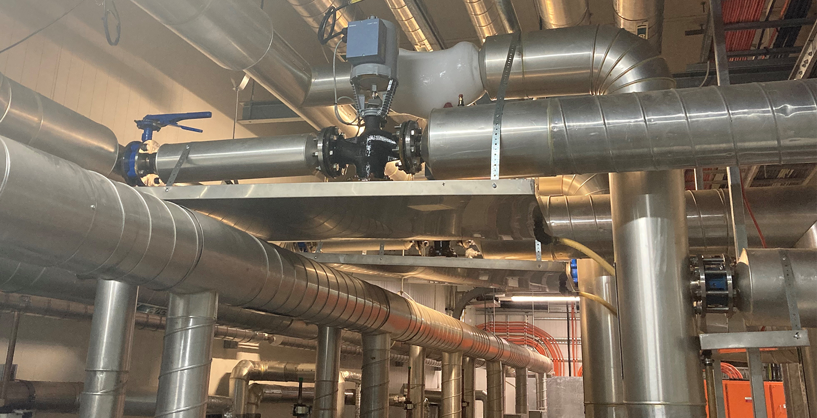 industrial refrigeration room with pipes and machinery