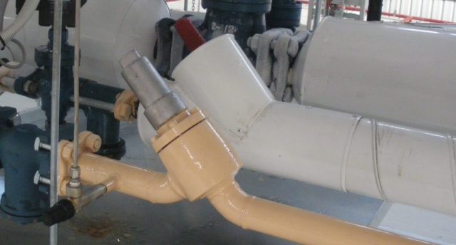 industrial refrigeration equipment including shut off valve, strainer, solenoid, suction stop in a plant room