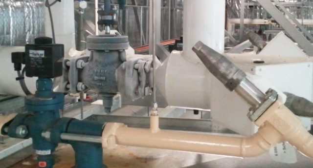 industrial refrigeration equipment including shut off valve, strainer, solenoid, suction stop in a plant room