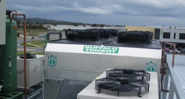 multiple industrial refrigeration equipment located on the building’s roof