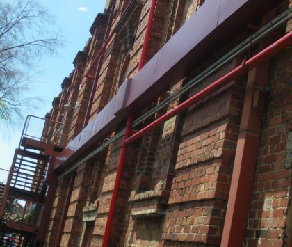 an outside side view of a red brick building