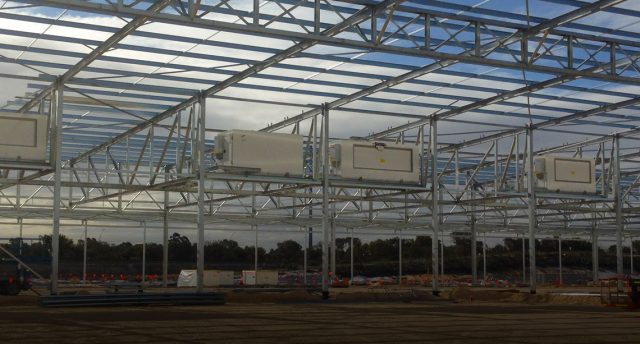 construction site with steel frame with five cabinet coolers established