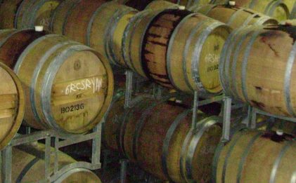 multiple wooden barrels stacked together in a room