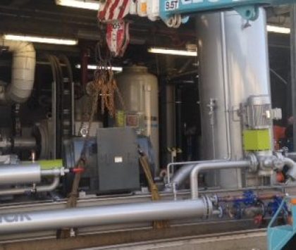 crane lowering an industrial refrigeration compressor package