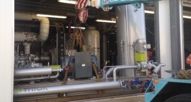 crane lowering an industrial refrigeration compressor package
