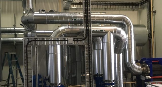 industrial refrigeration plantroom with multiple pieces of equipment