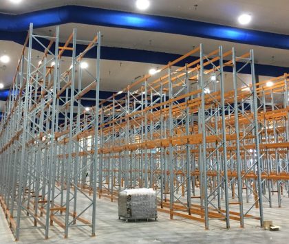 a cool room with racking in it and a pallet in the middle of the room