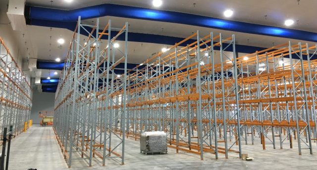 a cool room with racking in it and a pallet in the middle of the room