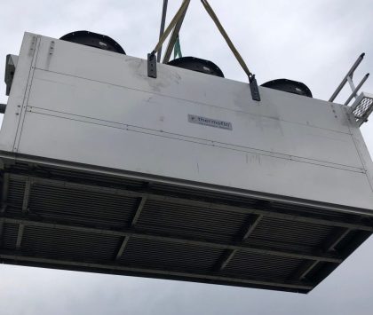 condenser being carried by a crane
