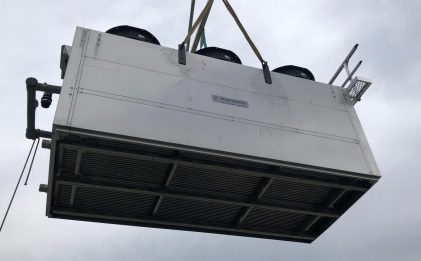 condenser being carried by a crane