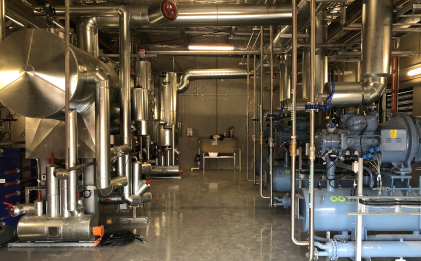 an industrial refrigeration site with equipment on each side of the photo