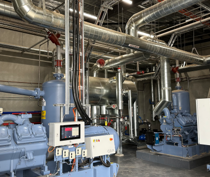 inside of an industrial refrigeration plantroom filled with equipment
