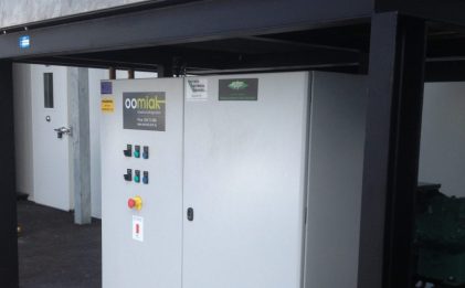 equipment under shelter outside with an oomiak logo on it