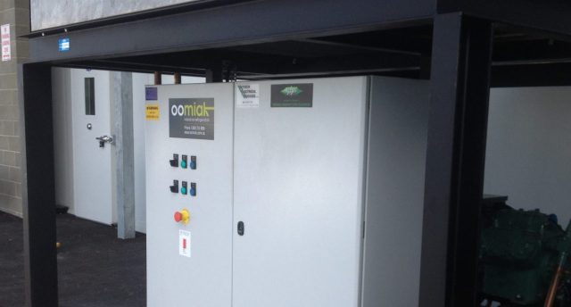 equipment under shelter outside with an oomiak logo on it