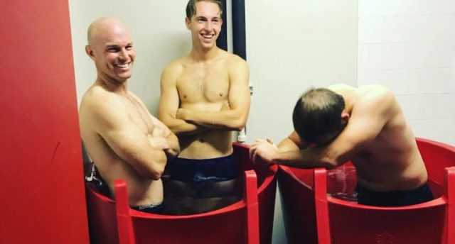 two ice baths with three men in them