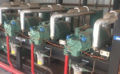 an industrial refrigeration plantroom with multiple pieces of equipment