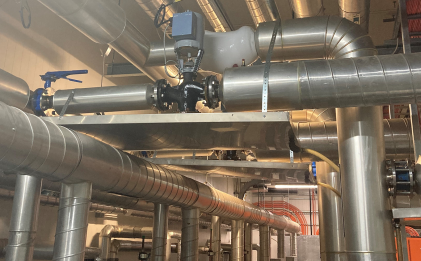 industrial refrigeration room with pipes and machinery