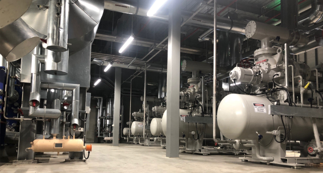 a cool room with multiple compressors and other industrial refrigeration equipment