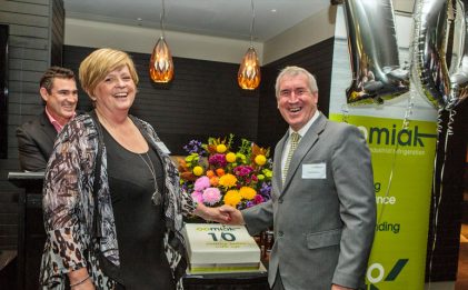 two business owners celebrating their company's tenth birthday